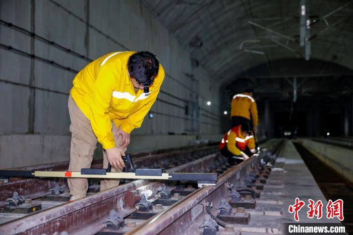 中国铁路南宁局集团有限公司南宁工务段职工使用道尺检查吴圩机场高铁站高铁线路设备。　韦刚 摄